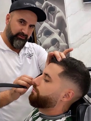 Barber shaping a beard at Broadway Barber Shop