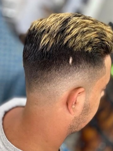 Blonde textured top over a skin fade